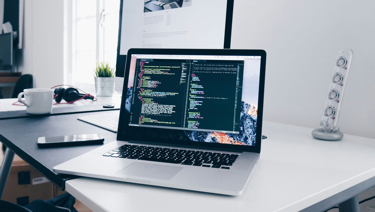 Laptop displaying HTML code for professional web design